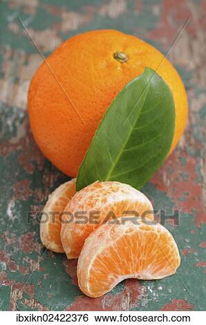 Mandarine and pieces of mandarine View Large Photo Image Stock Photograph - Mandarine and pieces of mandarine. Fotosearch