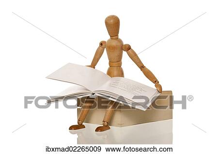 Stock Photo - Mannequin reading a book while sitting on a pile of books. Fotosearch