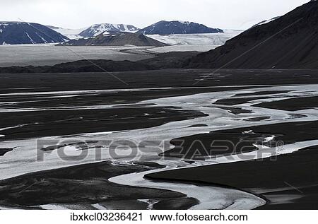 Stock Image - "Meandering river in front of mountains and a glacial landscape, Faksevagen, Lomfjorden, Spitsbergen Island, Svalbard Archipelago, Svalbard and Jan Mayen, Norway, Europe". Fotosearch