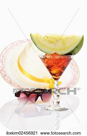 "Melon slice on cocktail glass in front of sun hat with sunglasses, symbolic image for a holiday in the south" View Large Photo Image Stock Image - "Melon slice on cocktail glass in front of sun hat with sunglasses, symbolic image for a holiday in the south". Fotosearch