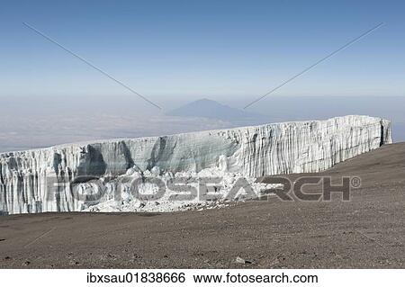 "Melting ice, broken ice wall, Kersten glacier on the crater rim of Kibo, summit of Uhuru Peak, extinct volcano, with Mount Meru in the distance, Kilimanjaro National Park, Marangu Route, Tanzania, East Africa, Africa" View Large Photo Image Stock Photograph - "Melting ice, broken ice wall, Kersten glacier on the crater rim of Kibo, summit of Uhuru Peak, extinct volcano, with Mount Meru in the distance, Kilimanjaro National Park, Marangu Route, Tanzania, East Africa, Africa". Fotosearch