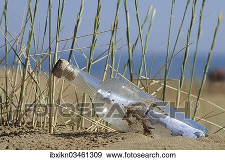 "Message in a bottle in sand on a beach, Georgioupolis, Crete, Greece, Europe" View Large Photo Image Stock Photo - "Message in a bottle in sand on a beach, Georgioupolis, Crete, Greece, Europe". Fotosearch