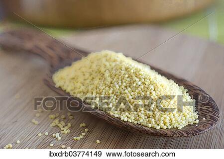 Millet grains on a wooden scoop made of coconut wood View Large Photo Image Stock Photo - Millet grains on a wooden scoop made of coconut wood. Fotosearch