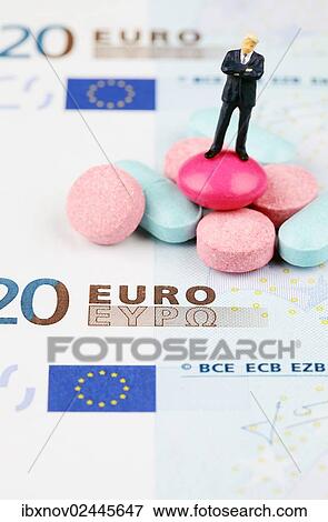 Miniature figurine of businessman standing on medical pills on euro banknote View Large Photo Image Stock Photo - Miniature figurine of businessman standing on medical pills on euro banknote. Fotosearch