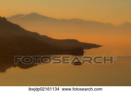 Picture - "Misty morning on the Great Salt Lake showing White Rock Bay and the Oquirrh Mountains from Buffalo Point on Antelope Island, Utah, USA". Fotosearch