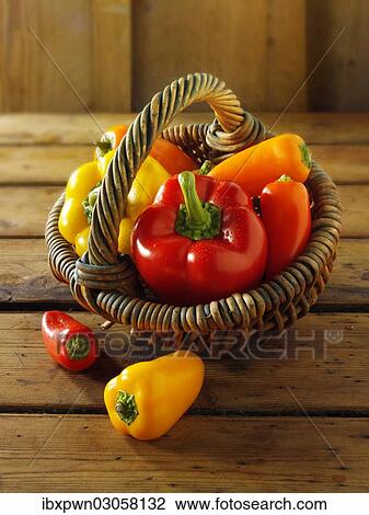 "Mixed fresh red, yellow and orange bell peppers in a basket" View Large Photo Image Stock Image - "Mixed fresh red, yellow and orange bell peppers in a basket". Fotosearch