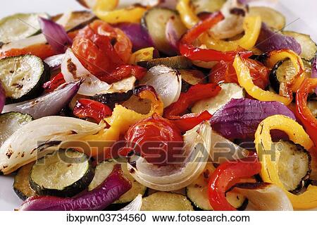Stock Image - "Mixed roast vegetables, onions, peppers and courgettes". Fotosearch