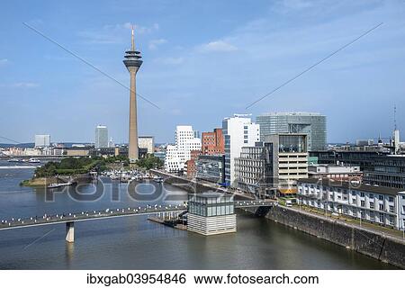 Stock Photograph - "Modern office buildings and Rhein Tower, Medienhafen or Media Harbour, Dusseldorf, Rhineland, North Rhine-Westphalia, Germany, Europe". Fotosearch