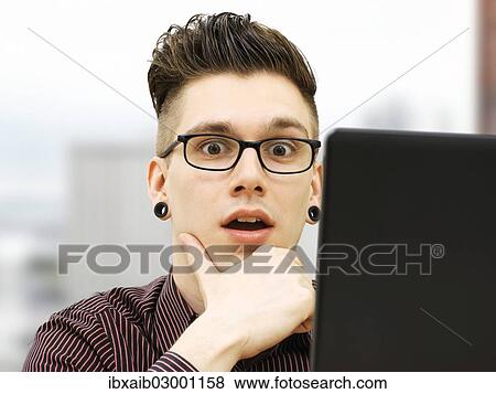 "Modern young business man, business-punk, working on a laptop" View Large Photo Image Stock Photo - "Modern young business man, business-punk, working on a laptop". Fotosearch