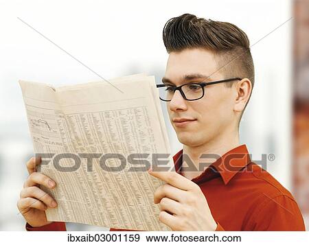 "Modern young business man, business-punk reading a newspaper" View Large Photo Image Stock Photo - "Modern young business man, business-punk reading a newspaper". Fotosearch