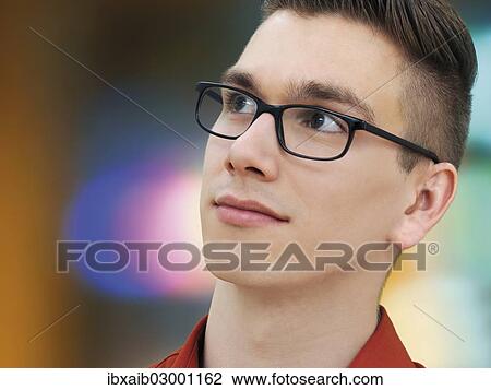 "Modern young man wearing glasses, portrait" View Large Photo Image Stock Image - "Modern young man wearing glasses, portrait". Fotosearch