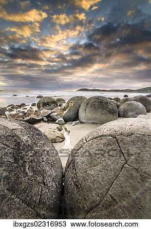 "Moeraki Boulders, geological feature, round rock balls, some fragments lying broken in ruins on the beach, Coastal Otago, Moeraki, South Island, New Zealand, Oceania" View Large Photo Image Stock Image - "Moeraki Boulders, geological feature, round rock balls, some fragments lying broken in ruins on the beach, Coastal Otago, Moeraki, South Island, New Zealand, Oceania". Fotosearch