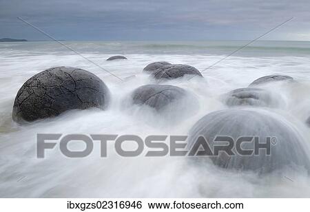 Stock Photograph - "Moeraki Boulders, geological feature, round rock balls, washed by the waves of the surf at high tide, Coastal Otago, Moeraki, South Island, New Zealand, Oceania". Fotosearch