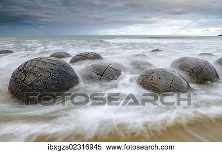 Stock Photography - "Moeraki Boulders, geological feature, round rock balls, washed by the waves of the surf at high tide, Coastal Otago, Moeraki, South Island, New Zealand, Oceania". Fotosearch