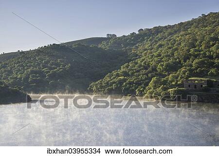 Picture - "Morning fog at the Alcantara Dam or Embalse de Jose Maria de Oriol-II Alcantara, Extremadura, Spain, Europe". Fotosearch