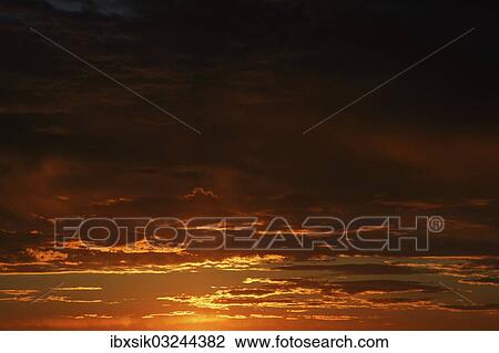 Stock Image - "Morning sky coloured red at dawn, Upper Swabia, Baden-Wurttemberg, Germany, Europe". Fotosearch