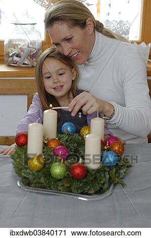 "Mother and daughter lighting the first candle on the Advent wreath, first Sunday in Advent" View Large Photo Image Stock Image - "Mother and daughter lighting the first candle on the Advent wreath, first Sunday in Advent". Fotosearch