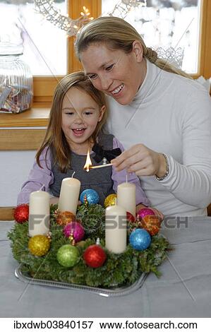 "Mother and daughter lighting the first candle on the Advent wreath, first Sunday in Advent" View Large Photo Image Stock Photo - "Mother and daughter lighting the first candle on the Advent wreath, first Sunday in Advent". Fotosearch