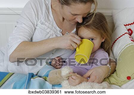 "Mother taking care of her sick daughter, dispensing hot tea, girl lying in bed" View Large Photo Image Stock Image - "Mother taking care of her sick daughter, dispensing hot tea, girl lying in bed". Fotosearch