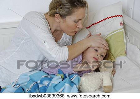 "Mother taking care of her sick daughter, child lying in bed" View Large Photo Image Stock Photo - "Mother taking care of her sick daughter, child lying in bed". Fotosearch