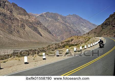 "Motorcyclist in the Andes on the road RA7, Ruta Nacional 7, between Mendoza, Argentina, and Santiago de Chile, Chile, South America" View Large Photo Image Stock Image - "Motorcyclist in the Andes on the road RA7, Ruta Nacional 7, between Mendoza, Argentina, and Santiago de Chile, Chile, South America". Fotosearch