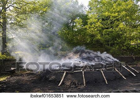 "Mound of burning charcoal in the final stage, Walpersdorf, Siegen-Wittgenstein district, North Rhine-Westphalia, Germany, Europe" View Large Photo Image Stock Image - "Mound of burning charcoal in the final stage, Walpersdorf, Siegen-Wittgenstein district, North Rhine-Westphalia, Germany, Europe". Fotosearch