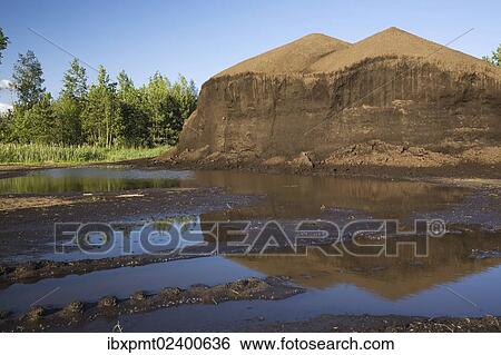 "Mound of topsoil in a commercial sandpit after a heavy rainfall, Quebec, Canada, North America" View Large Photo Image Stock Photograph - "Mound of topsoil in a commercial sandpit after a heavy rainfall, Quebec, Canada, North America". Fotosearch