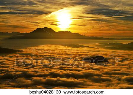 Stock Image - "Mount Pilatus above fog at sunset, Canton of Zug, Switzerland, Europe". Fotosearch