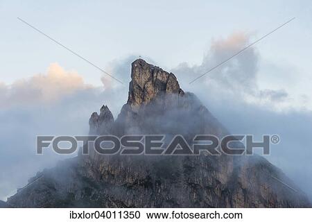 "Mount Sass de Stria in the clouds at sunrise, Falzarego pass, Dolomites, Veneto, Italy, Europe" View Large Photo Image Stock Image - "Mount Sass de Stria in the clouds at sunrise, Falzarego pass, Dolomites, Veneto, Italy, Europe". Fotosearch