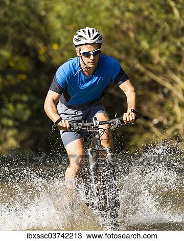 "Mountain biker crossing a stream, Winterbach, Baden-Wurttemberg, Germany, Europe" View Large Photo Image Stock Image - "Mountain biker crossing a stream, Winterbach, Baden-Wurttemberg, Germany, Europe". Fotosearch