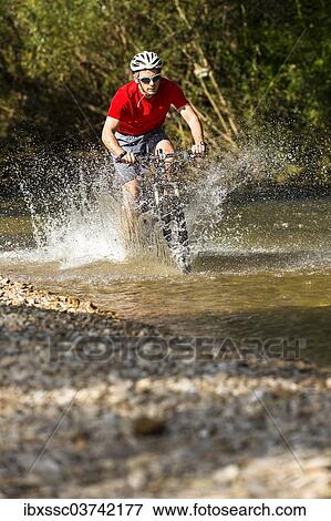 "Mountain biker crossing a stream, Winterbach, Baden-Wurttemberg, Germany, Europe" View Large Photo Image Stock Photo - "Mountain biker crossing a stream, Winterbach, Baden-Wurttemberg, Germany, Europe". Fotosearch