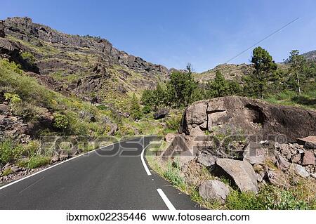 Stock Photograph - "Mountain chain and a country road, El Pie de la Cuesta, Roque Bentaiga, Gran Canaria, Canary Islands, Spain, Europe, PublicGround, Europe". Fotosearch