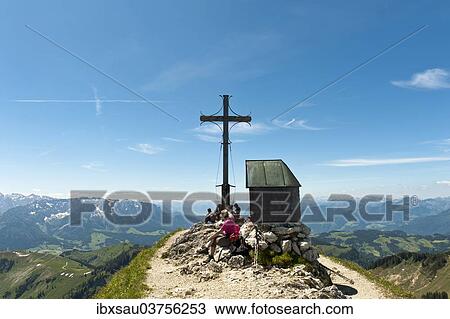 "Mountain climber at the summit cross with a small chapel on Geigelstein Mountain, 1808 m, Geigelstein Nature Reserve, Aschau im Chiemgau, Upper Bavaria, Bavaria, Germany, Europe" View Large Photo Image Stock Image - "Mountain climber at the summit cross with a small chapel on Geigelstein Mountain, 1808 m, Geigelstein Nature Reserve, Aschau im Chiemgau, Upper Bavaria, Bavaria, Germany, Europe". Fotosearch