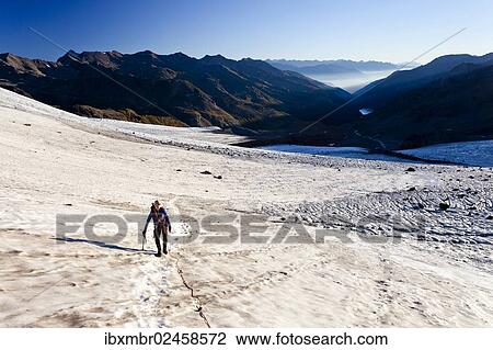 Stock Image - "Mountain climber on Fuerkeleferner Mountain, overlooking the Martell Valley, Alto Adige, Italy, Europe". Fotosearch