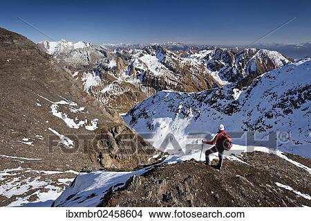 "Mountain climber on the summit ridge while descending from Wilde Kreuzspitze Mountain in the Pfunderer Mountains, overlooking the Vals Valley and Wurmaulspitz Mountain, Alto Adige, Italy, Europe" View Large Photo Image Picture - "Mountain climber on the summit ridge while descending from Wilde Kreuzspitze Mountain in the Pfunderer Mountains, overlooking the Vals Valley and Wurmaulspitz Mountain, Alto Adige, Italy, Europe". Fotosearch
