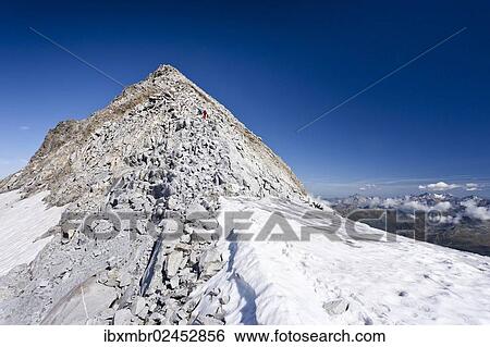 Stock Photograph - "Mountain climbers during the ascent of Fernerkoepfl Mountain in the Rieserferner Group in the Puster Valley, looking towards the summit of Fernerkoepfl Mountain, Alto Adige, Italy, Europe". Fotosearch