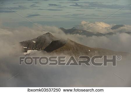 "Mountain landscape in the evening light with looming clouds, Slaettaratindur, Eysturoy, Faroe Islands, Denmark, Europe" View Large Photo Image Stock Image - "Mountain landscape in the evening light with looming clouds, Slaettaratindur, Eysturoy, Faroe Islands, Denmark, Europe". Fotosearch