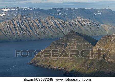Stock Photo - "Mountain landscape in the evening light, islands of Kalsoy and Kunoy at the rear, Slaettaratindur, Eysturoy, Faroe Islands, Denmark, Europe". Fotosearch