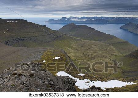 Stock Photo - "Mountain landscape in the evening light, islands of Kalsoy and Kunoy at the rear, Slaettaratindur, Eysturoy, Faroe Islands, Denmark, Europe". Fotosearch