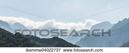 "Mountain landscape, silhouettes of mountain ridges with clouds, Corsica, France, Europe" View Large Photo Image Stock Photo - "Mountain landscape, silhouettes of mountain ridges with clouds, Corsica, France, Europe". Fotosearch