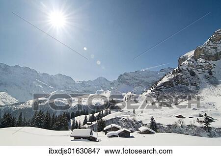 Stock Photo - "Mountain panorama with the sun, Muerren, Canton Bern, Switzerland, Europe". Fotosearch