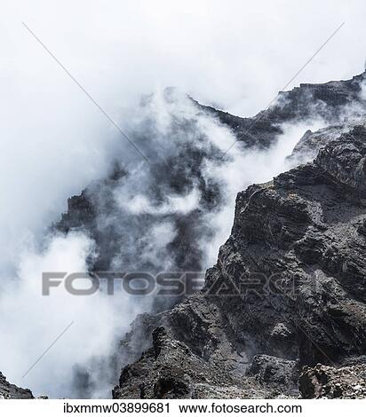Stock Image - "Mountain slopes shrouded in clouds, lava landscape, Roque de los Muchachos, Caldera de Taburiente National Park, La Palma, Canary Islands, Spain, Europe". Fotosearch