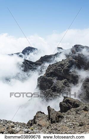 Stock Photo - "Mountain slopes shrouded in clouds, lava landscape, Roque de los Muchachos, Caldera de Taburiente National Park, La Palma, Canary Islands, Spain, Europe". Fotosearch