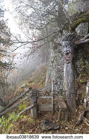 "Mountain spirit, eerie face carved into a tree, forest path in the fog, autumn, Seiser Alm am Puflatsch, Alpe di Siusi, Schlern-Rosengarten Nature Park, Dolomites, Alto Adige, Trentino-Alto Adige, Italy, Europe" View Large Photo Image Stock Photo - "Mountain spirit, eerie face carved into a tree, forest path in the fog, autumn, Seiser Alm am Puflatsch, Alpe di Siusi, Schlern-Rosengarten Nature Park, Dolomites, Alto Adige, Trentino-Alto Adige, Italy, Europe". Fotosearch