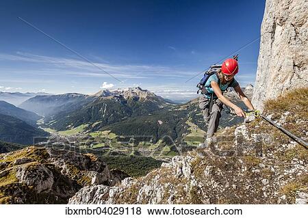 "Mountaineer during the ascent to Cima Valacia on the Via Ferrata F. Gadotti in the Val San Nicolo di Fassa, in the back of the Latemar, below the Val di Fassa and Moena, Dolomites, Pozza di Fassa Trentino Province, Trentino-Alto Adige, Italy, Europe" View Large Photo Image Stock Photo - "Mountaineer during the ascent to Cima Valacia on the Via Ferrata F. Gadotti in the Val San Nicolo di Fassa, in the back of the Latemar, below the Val di Fassa and Moena, Dolomites, Pozza di Fassa Trentino Province, Trentino-Alto Adige, Italy, Europe". Fotosearch