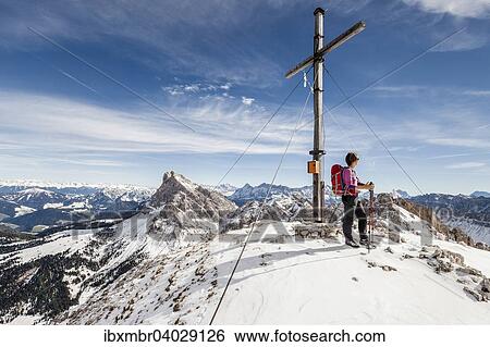 Stock Photograph - "Mountaineer on the summit of Mt Tullen, Val di Funes, Mt Peiterkofel at the back, Dolomites, Funes, Eisacktal valley, Province of South Tyrol, Trentino-Alto Adige, Italy, Europe". Fotosearch