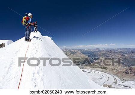 "Mountaineer on the summit ridge, ascent to Mt Piz Palue, summit of Mt Piz Palue at back, Pers Galcier below, Grisons, Switzerland, Europe" View Large Photo Image Stock Image - "Mountaineer on the summit ridge, ascent to Mt Piz Palue, summit of Mt Piz Palue at back, Pers Galcier below, Grisons, Switzerland, Europe". Fotosearch