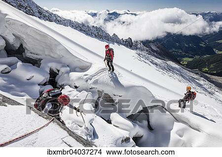 "Mountaineers ascending Mt Loffler via Trippachkees, snow divide, rope team at the marginal crevasse of Trippachscharte, Ahrntal Valley, Tauferer Ahrntal Valley and Puster Valley below, South Tyrol, Italy, Europe" View Large Photo Image Picture - "Mountaineers ascending Mt Loffler via Trippachkees, snow divide, rope team at the marginal crevasse of Trippachscharte, Ahrntal Valley, Tauferer Ahrntal Valley and Puster Valley below, South Tyrol, Italy, Europe". Fotosearch