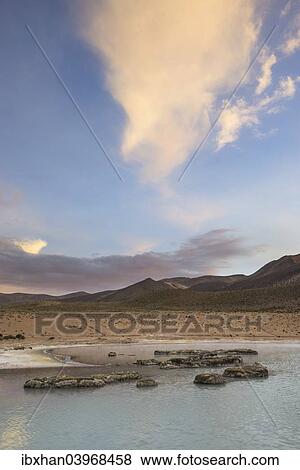 "Mountains and clouds in the evening light, at the salt lake Salar de Surire, Putre, Arica y Parinacota Region, Chile, South America" View Large Photo Image Stock Photo - "Mountains and clouds in the evening light, at the salt lake Salar de Surire, Putre, Arica y Parinacota Region, Chile, South America". Fotosearch
