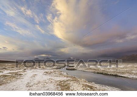 Stock Photograph - "Mountains and clouds in the evening light, at the salt lake Salar de Surire, Putre, Arica y Parinacota Region, Chile, South America". Fotosearch